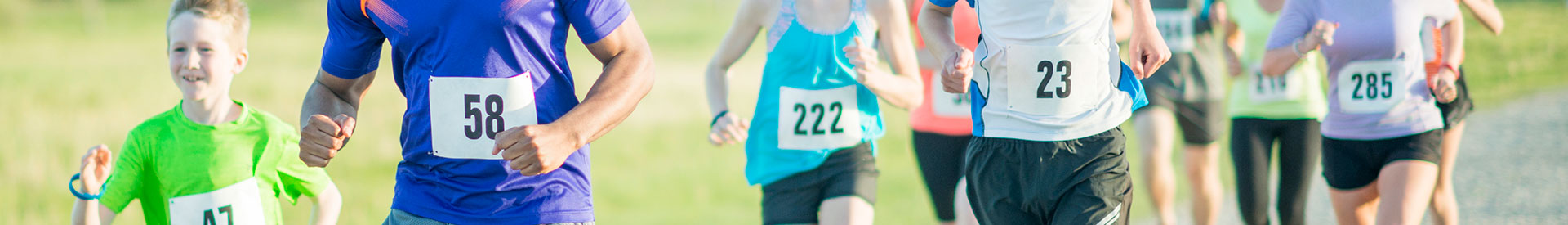 Diverse group of individuals running a marathon on a sunny day