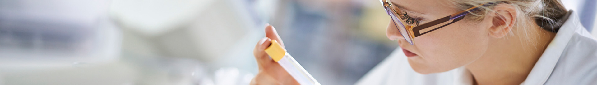 Lab worker examining test tube