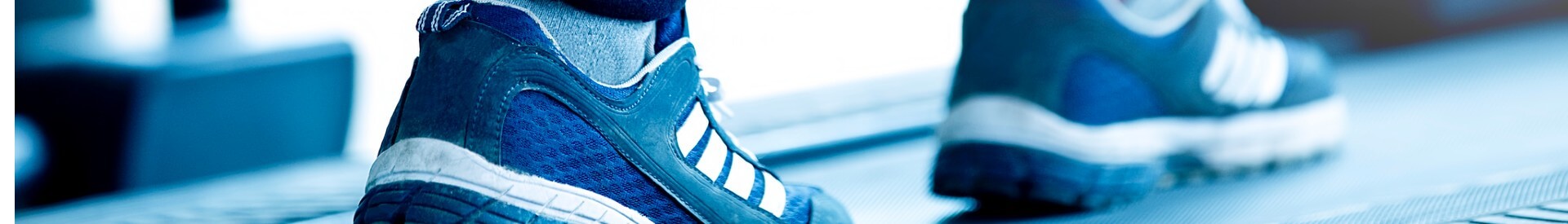 Feet of someone walking on a treadmill