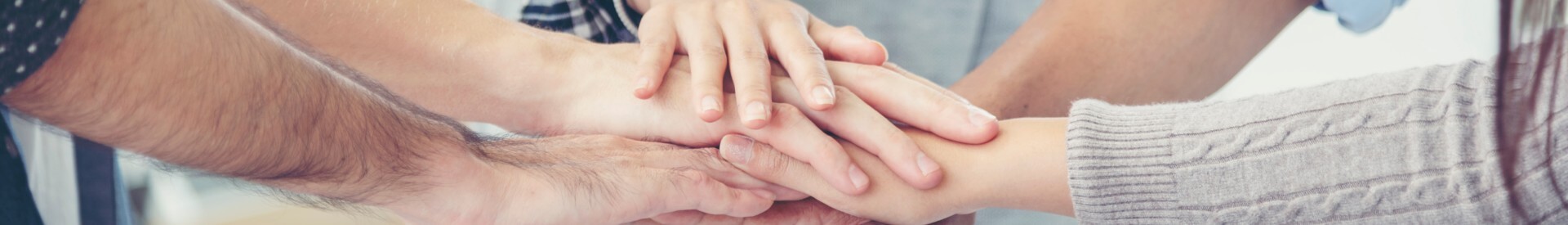 People Stacking Their Hands Together